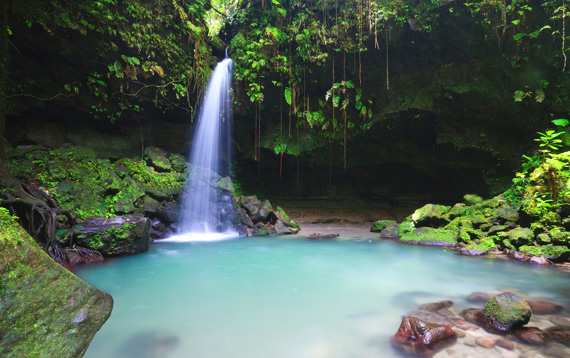 A beautiful waterfall and emerald pool on the island of Dominica, Caribbean.