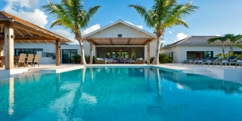 The freshwater, infinity edge swimming pool and spacious terrace at villa Castaway, Thompson Cove, Providenciales (Provo), Turks and Caicos Islands.